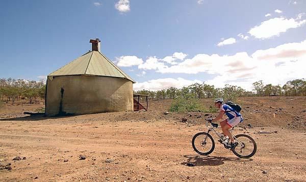 Riders pass an old mine site.