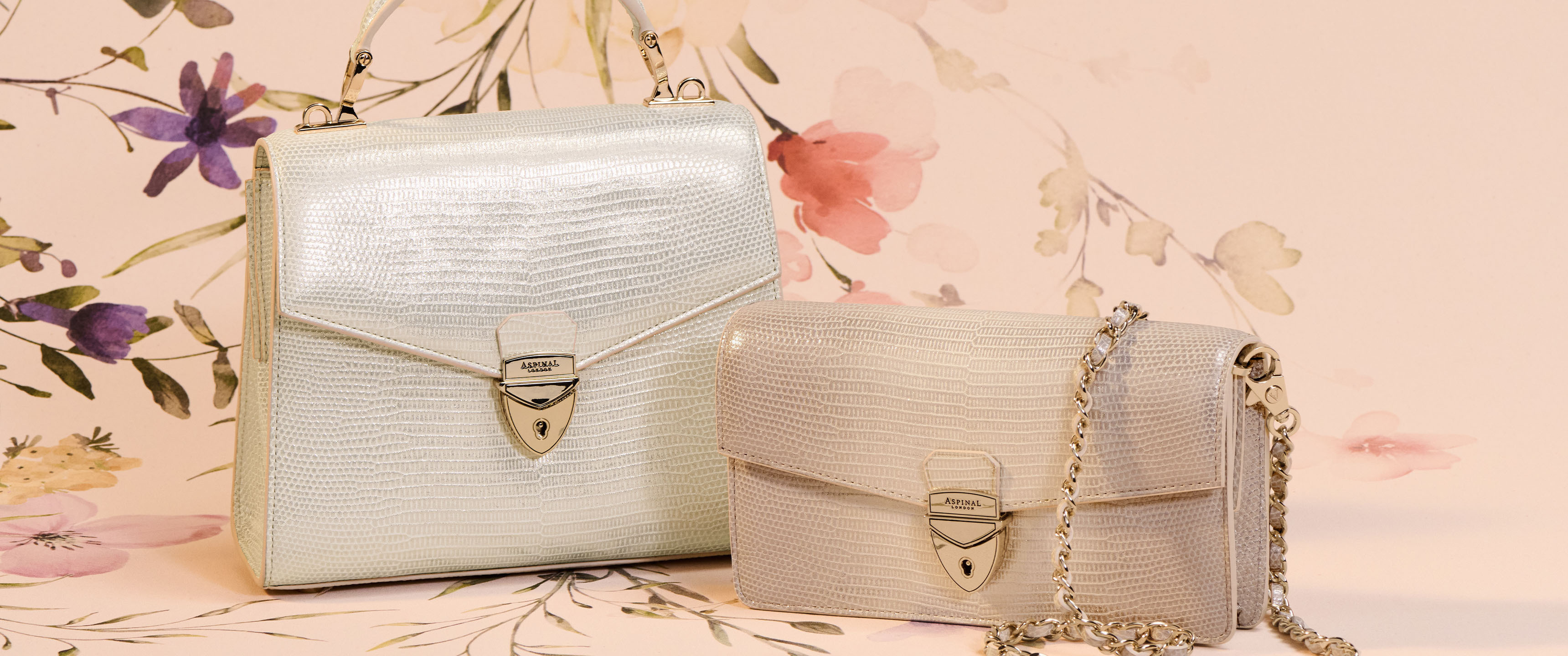 White and beige Aspinal of London handbags on floral background for Aspinal of London discount codes