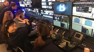 A production crew at Bentley University operate the robotic cameras during the games.