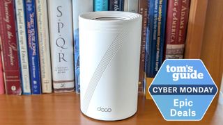 A TP-Link Deco BE63 mesh router with a Tom's Guide Cyber Monday deals badge