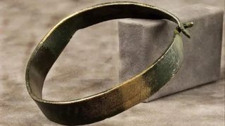 a photograph of a bronze bracelet
