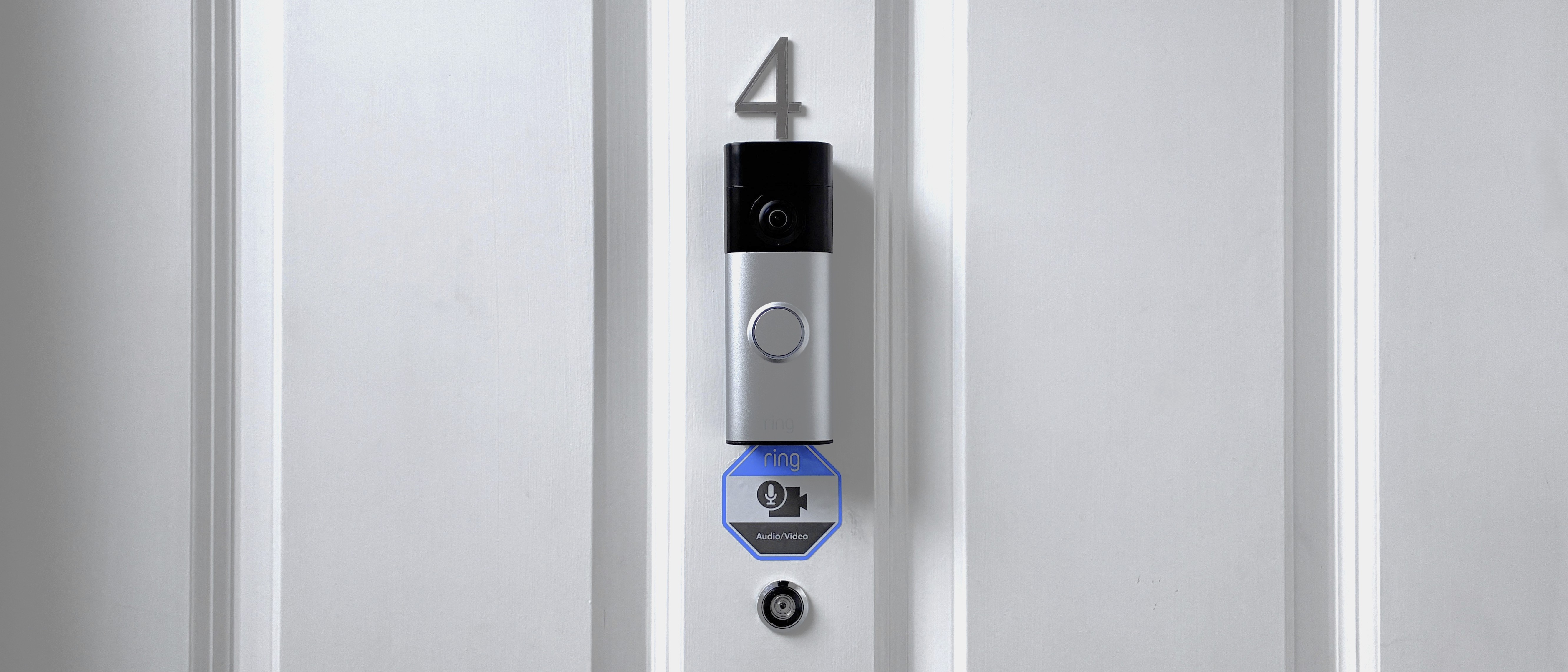 Ring Battery Video Doorbell Plus (2nd Gen) mounted above peephone on front door