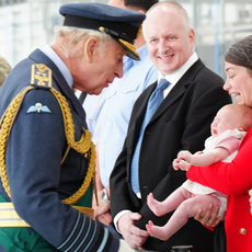 King Charles wears military uniform and meets a crowd of people including an unhappy baby