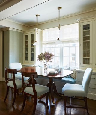 eat in kitchen with oval table and cream cabinets