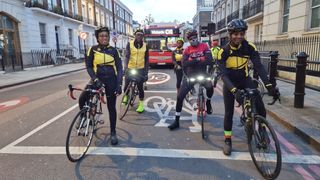 Together We Ride cyclists at a set of traffic lights