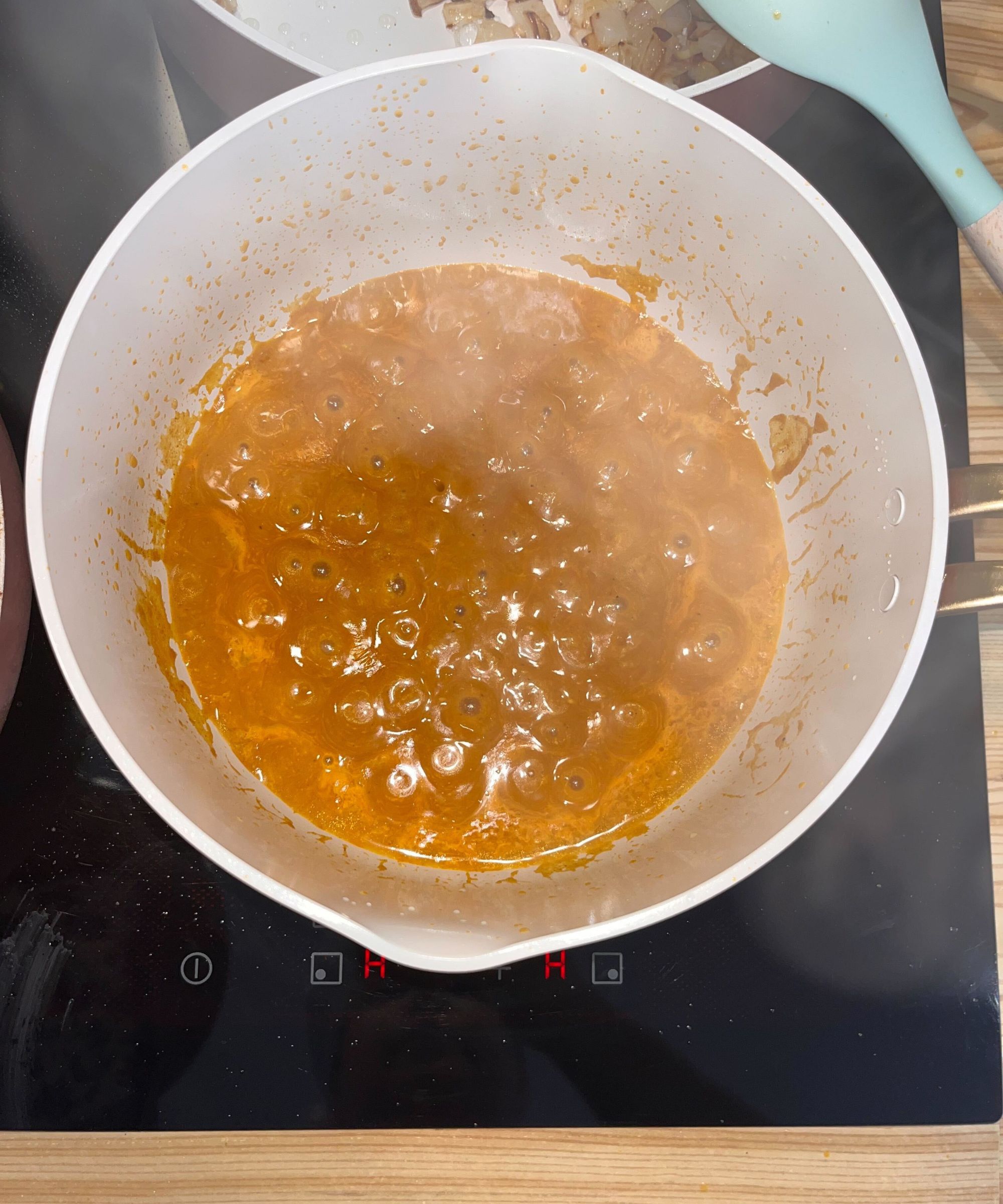 Simmering a light brown Katsu curry sauce in the Our Place frying pan from the Essentials 11-Piece Set - it is evenly bubbling from center to sides