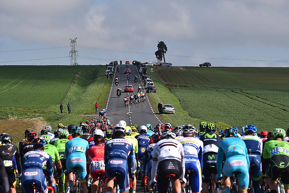 A group of riders heads up the road early on at Paris-Roubaix