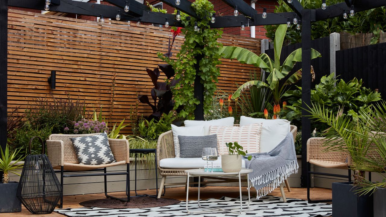 Raised deck in garden with pergola and garden seating