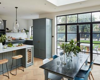 modern kitchen with large crittal windows looking out onto backyard