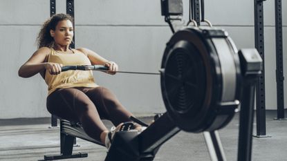 Woman doing a rowing for weight loss session
