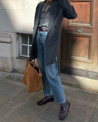 @lucyalston_ wearing a winter outfit with loafers and socks.