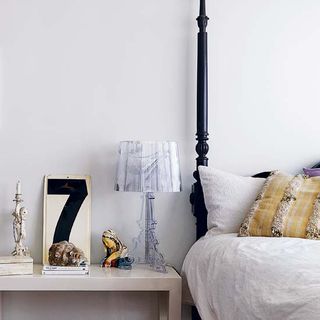 bedroom with white wall and table lamp