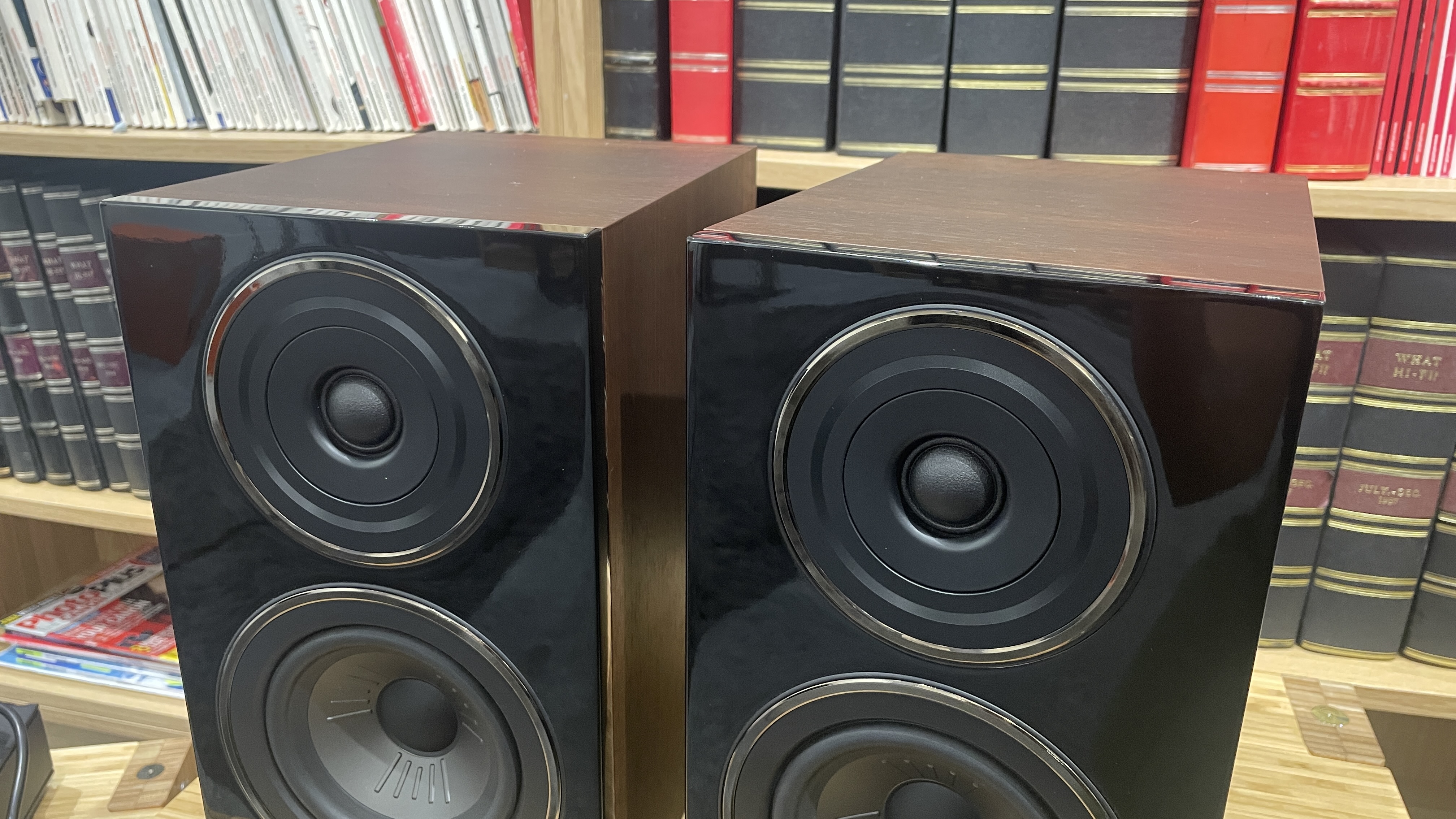 Wharfedale Diamond 12.1 stereo speakers in walnut veneer finish on a wooden rack