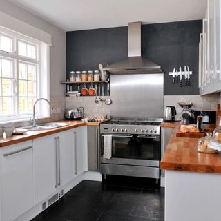 kitchen room with wooden worktop and cabinets