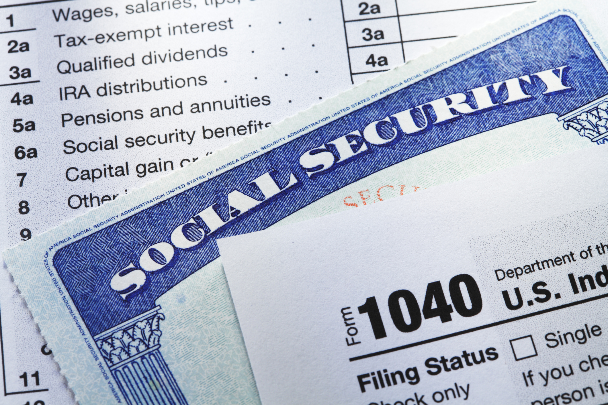 A Social Security card rests in between the pages of a 1040 tax form