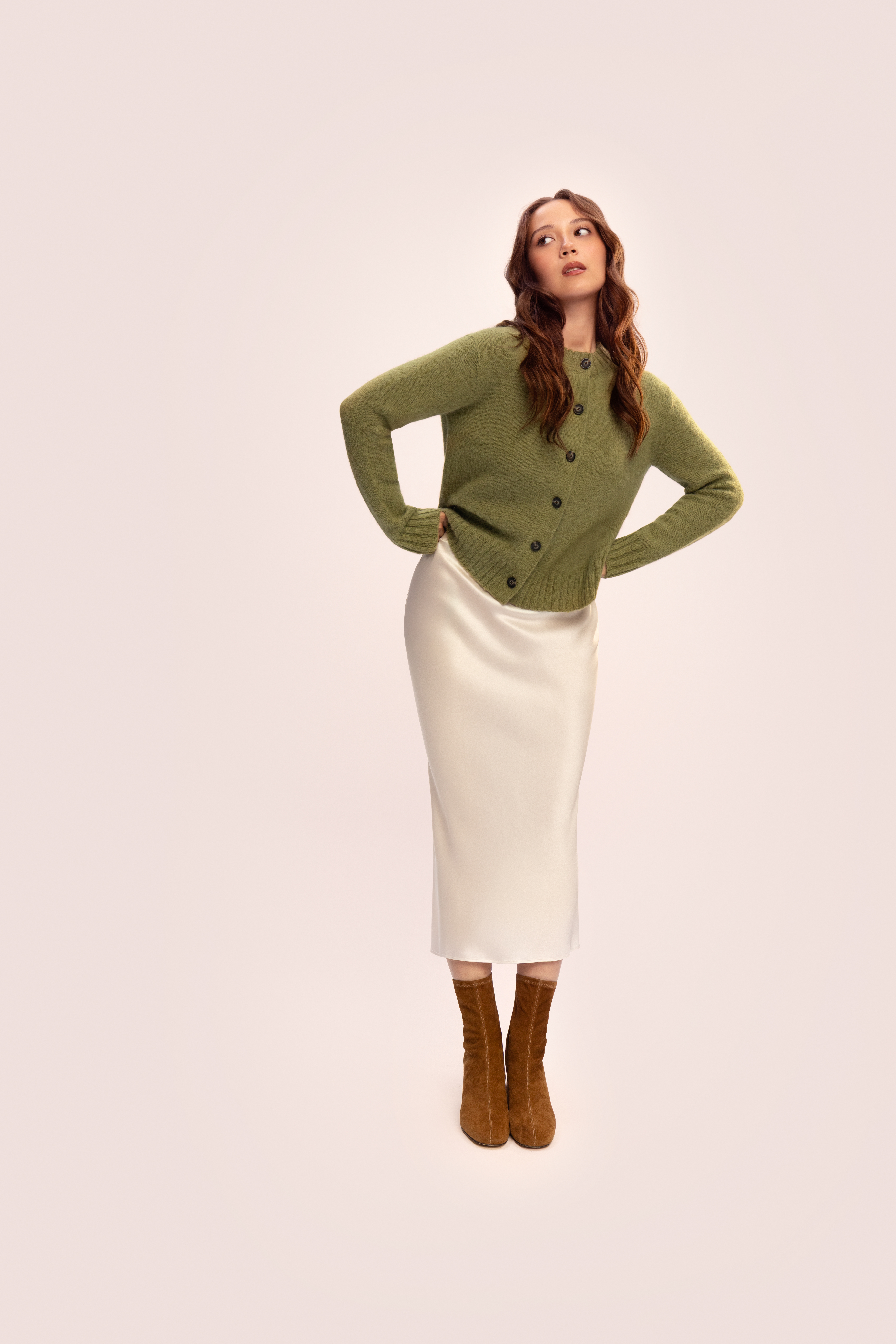 Laufey posing for Everlane&#039;s Fall 2025 Campaign, wearing a sweater, a slip skirt, and boots