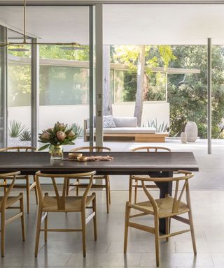 Wooden curved dining chairs, dark wooden table, glass door
