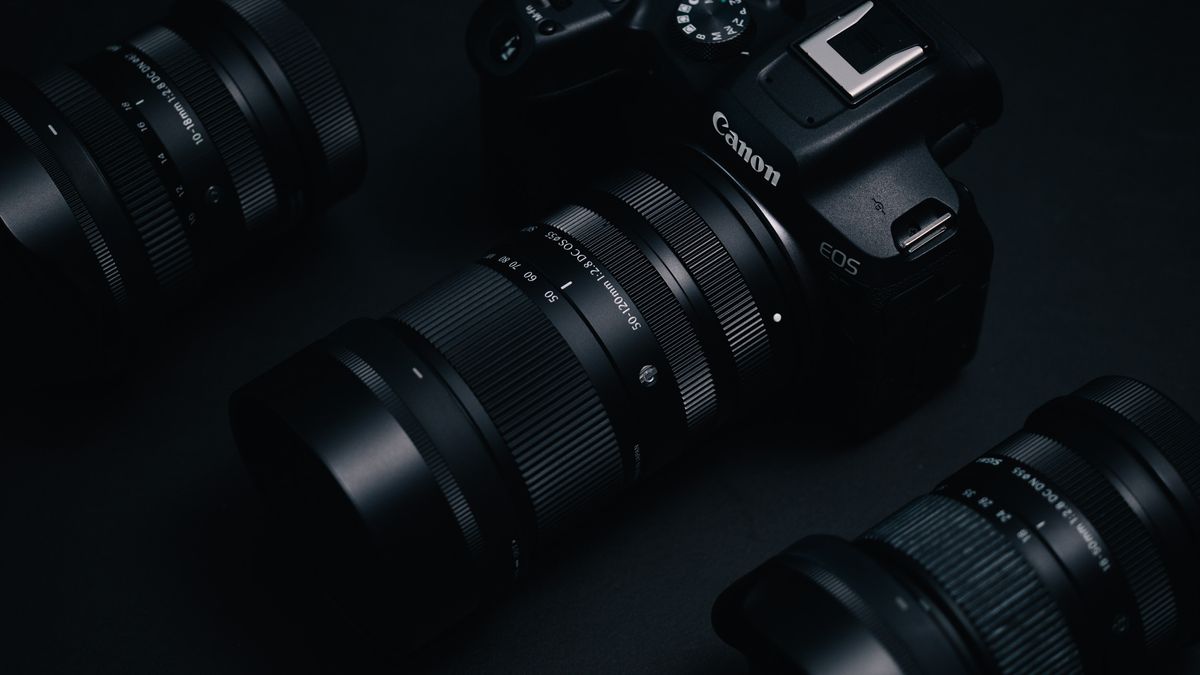 Sigma 50-120mm F2.8 DC OS Contemporary lens attached to a Canon EOS R7, in a lowkey lit studio with dark background