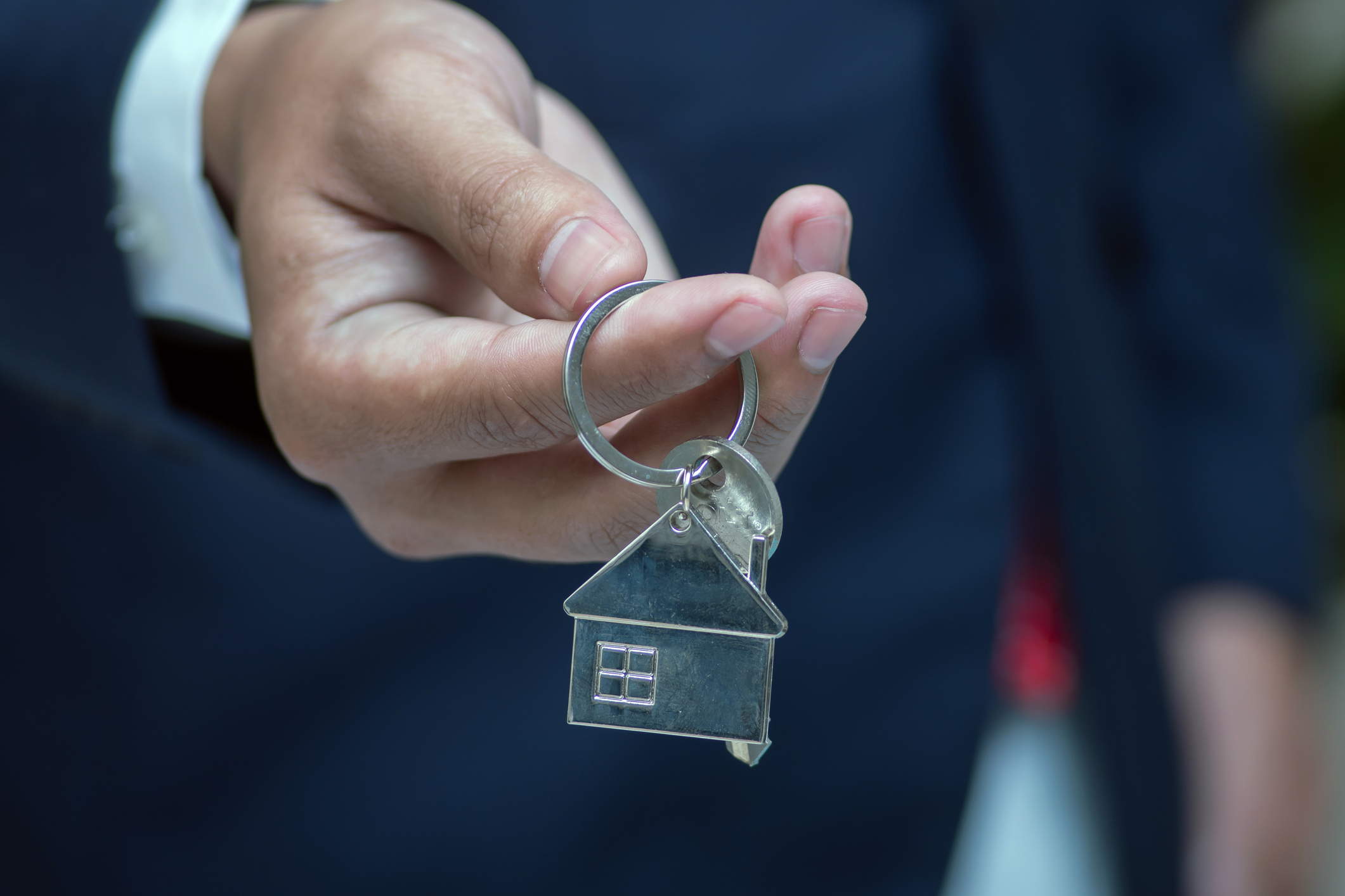 Real estate agent handing over house keys