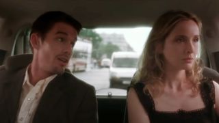 Ethan Hawke looking at Julie Delpy, they're both riding in the back of a car.