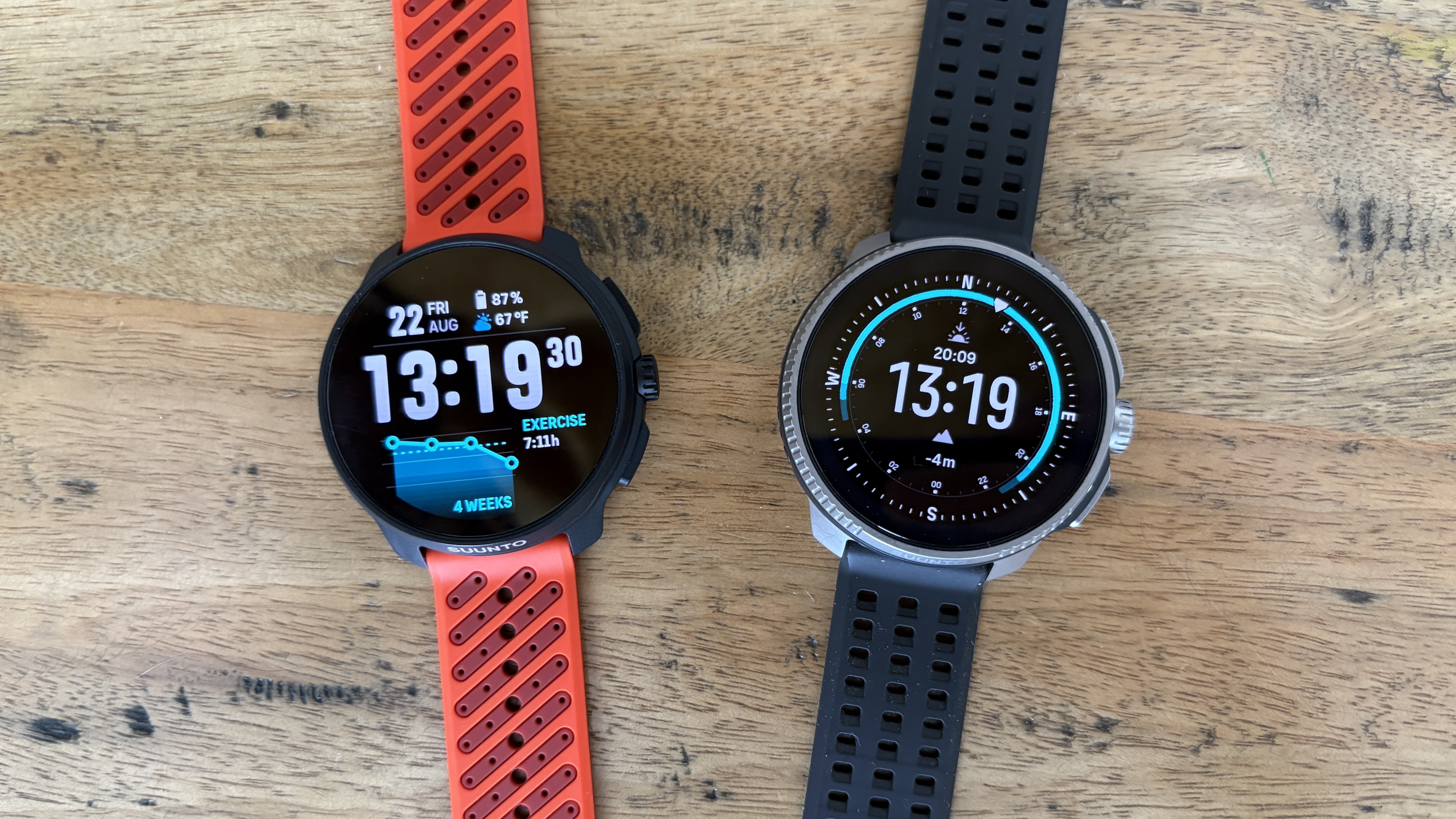 Suunto Race 2 next to the Suunto Race on a wooden table