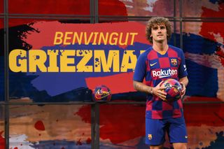 Antoine Griezmann poses for the media after signing for Barcelona in 2019.