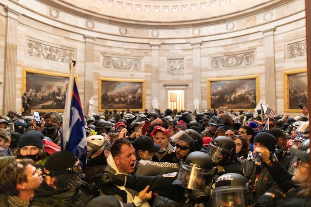 Police officers intervene after Trump supporters breached security and entered the Capitol building in Washington, on Jan. 6, 2021.