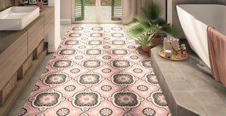 Stone bathroom with pink patterned floors tiles to show a key flooring trend 2023