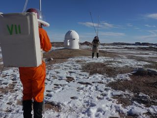 Crew 133 members setting up a radio telescope