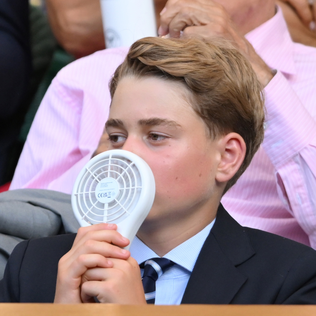 Prince George using a battery operated fan