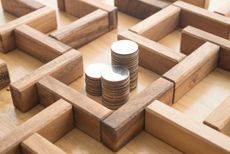 coins in the middle of a wooden maze