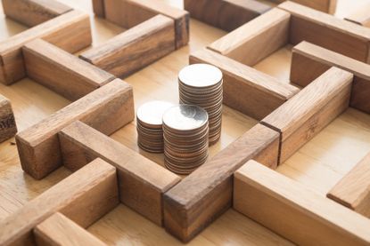 coins in the middle of a wooden maze