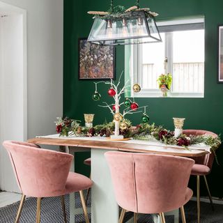 green dining room with pink velvet chairs