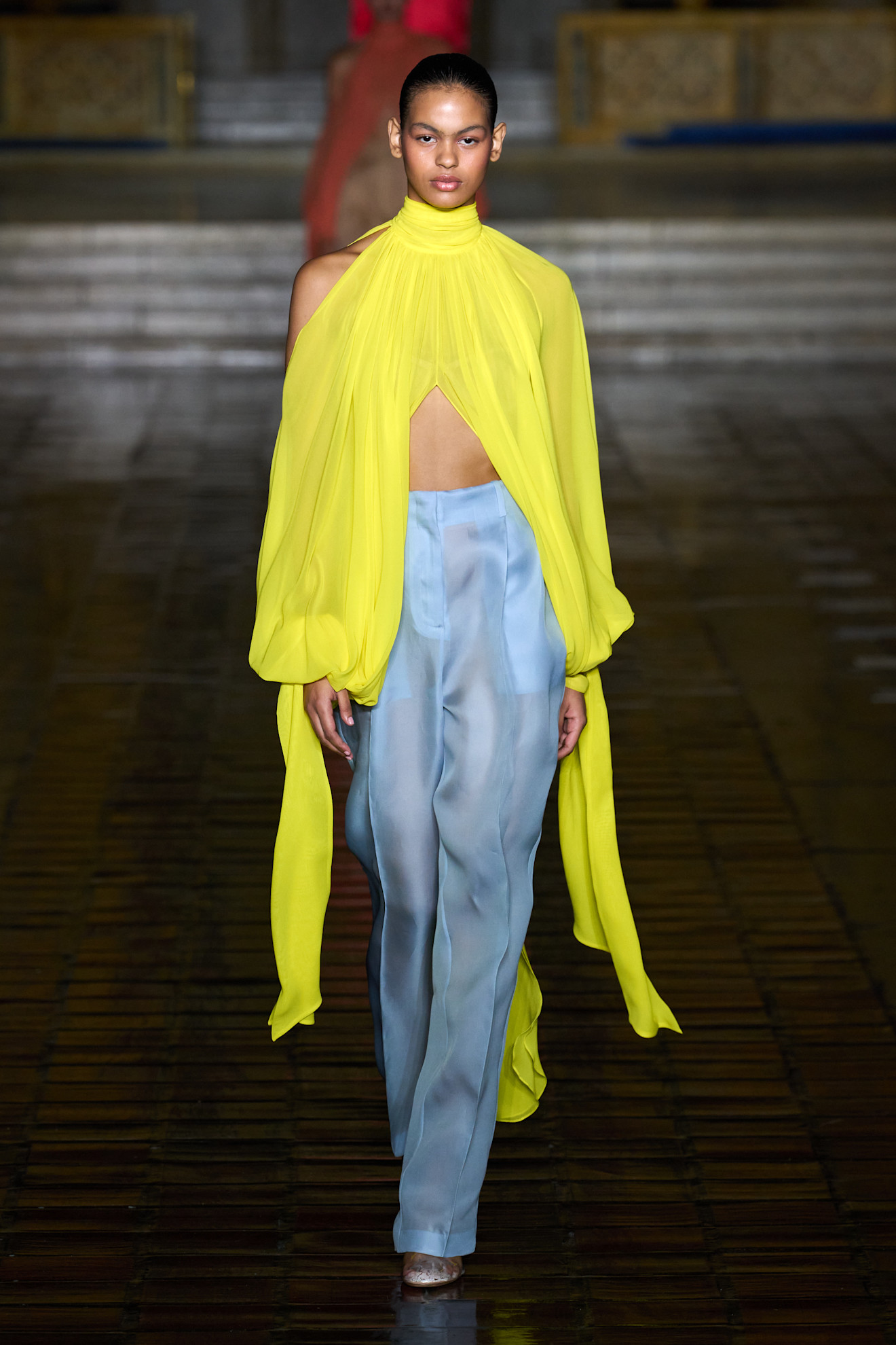 A woman walks down the runway in an unexpected color combination