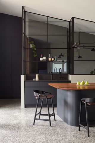 a kitchen with an exposed aggregate concrete flooring