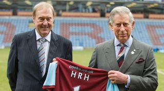 King Charles being presented with a Burnley shirt on his visit to Turf Moor in 2010