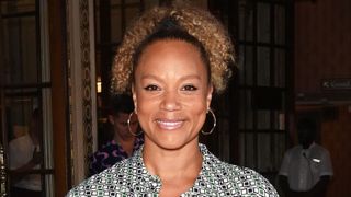 Angela Griffin with her hair up, smiling at the camera.