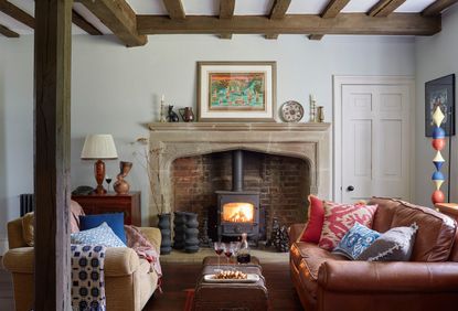 living room with fireplace and log-burner, leather sofa and corduroy armchair