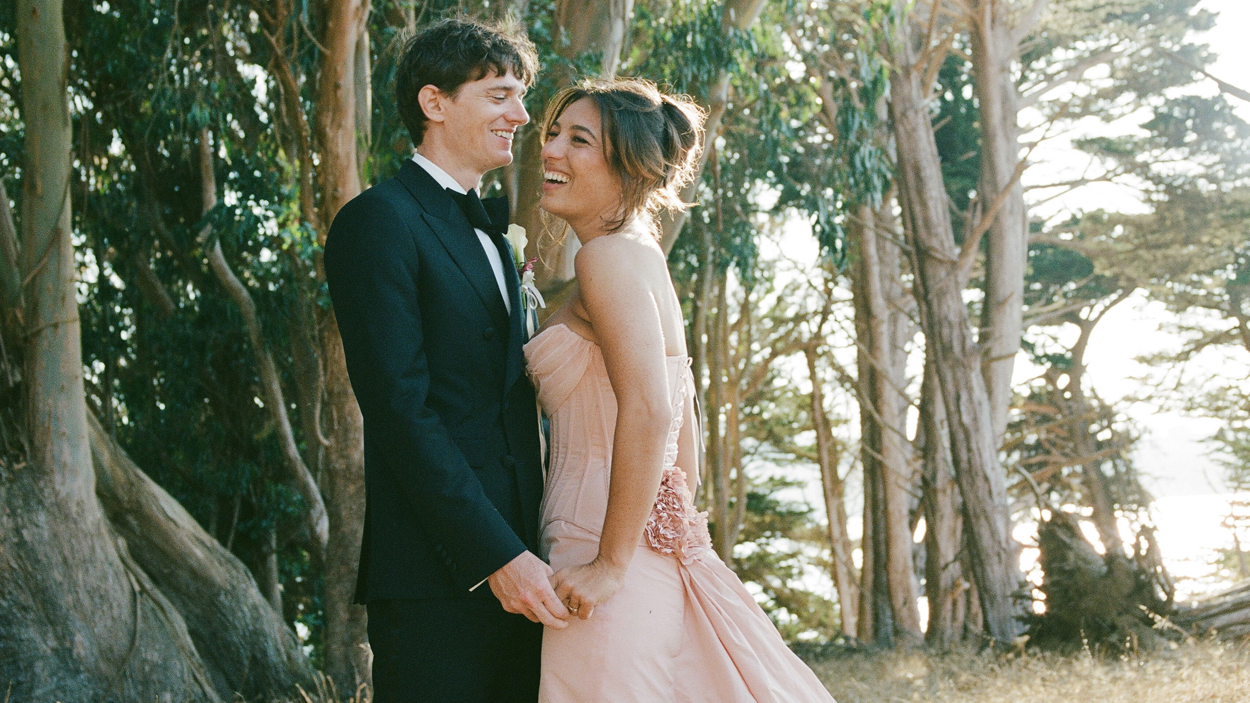 Hadley and Charles walking down the aisle after getting married.