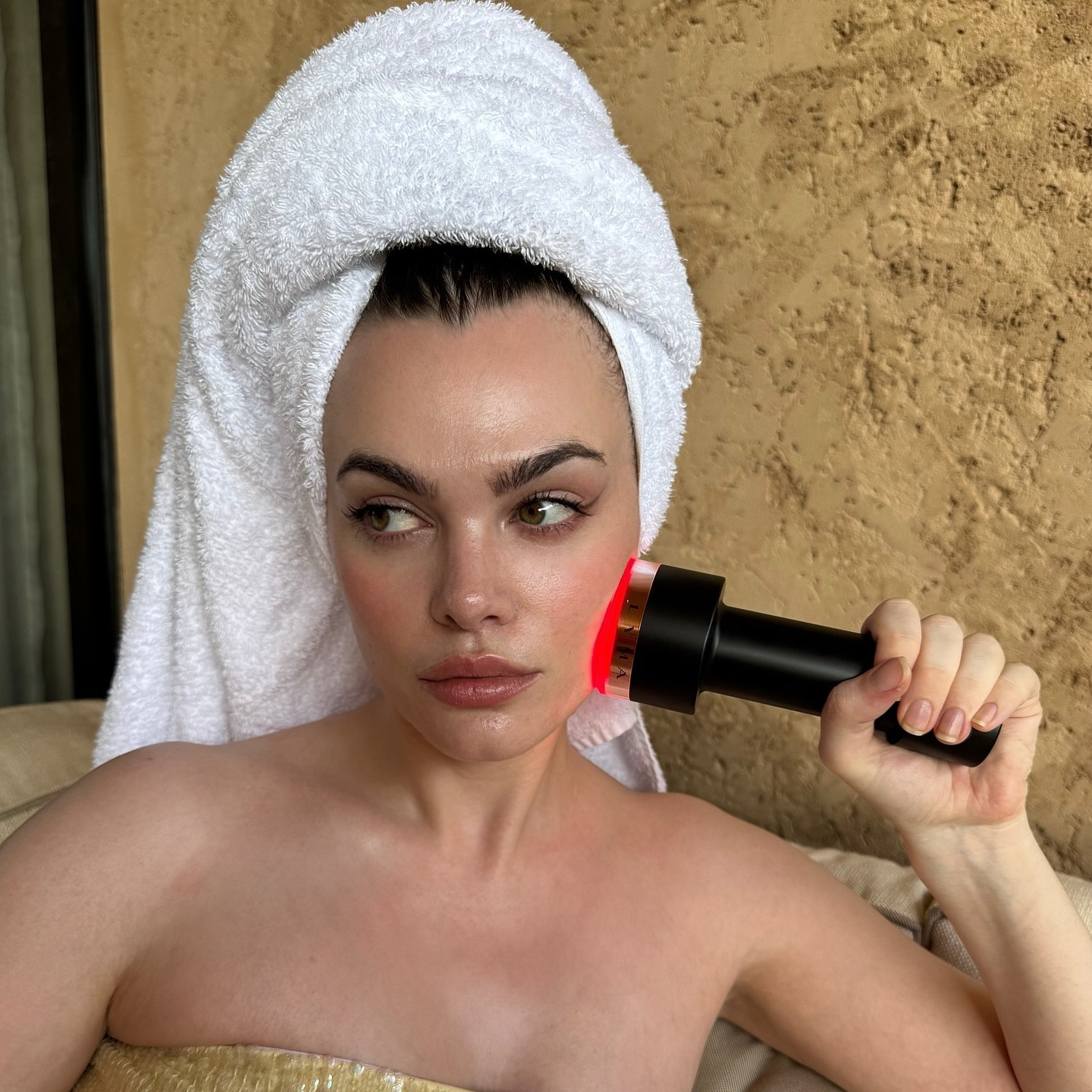 Photo of Charli Howard using the Lyma Laser Pro