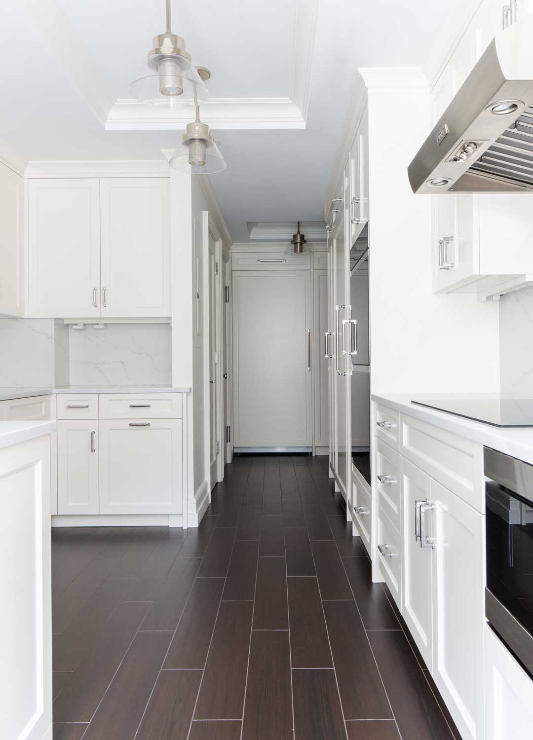 modern white galley kitchen with slate plank flooring