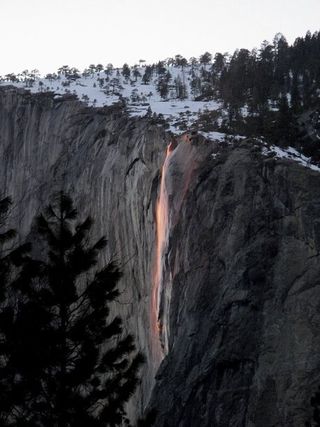 Yosemite National Park's Horsetail Falls lit up by the sun's rays