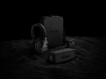 Three limited edition black diamond coloured headphones, earphones and speakers on a black background