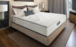 Marriott innerspring mattress on a beige platform bed with a headboard in a hotel room