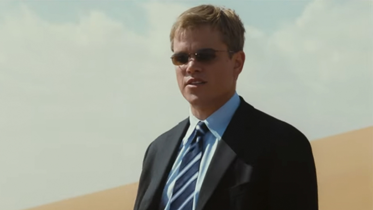 Matt Damon in a suit and sunglasses in the desert in Syriana