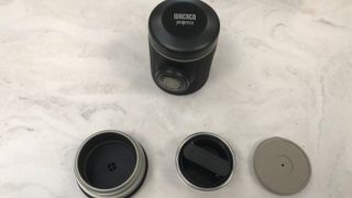 Wacaco Picopresso in parts on a marble countertop