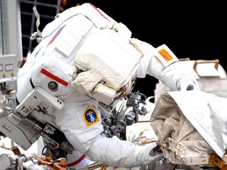 NASA astronaut Victor Glover, seen here in a photograph taken by Japan Aerospace Exploration Agency (JAXA) astronaut Soichi Noguchi from inside the International Space Station, conducts a spacewalk with NASA astronaut Michael Hopkins on Saturday, March 13, 2021.