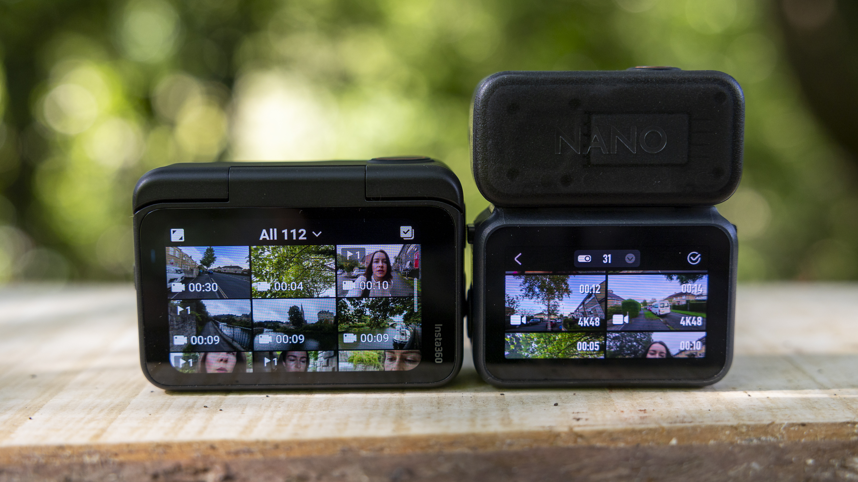 The DJI Osmo Nano and Insta360 Go Ultra next to each other on a bench in a sunny wood