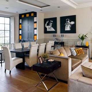 living and dining area with wooden floor and sofa and cushions and dining table and chair