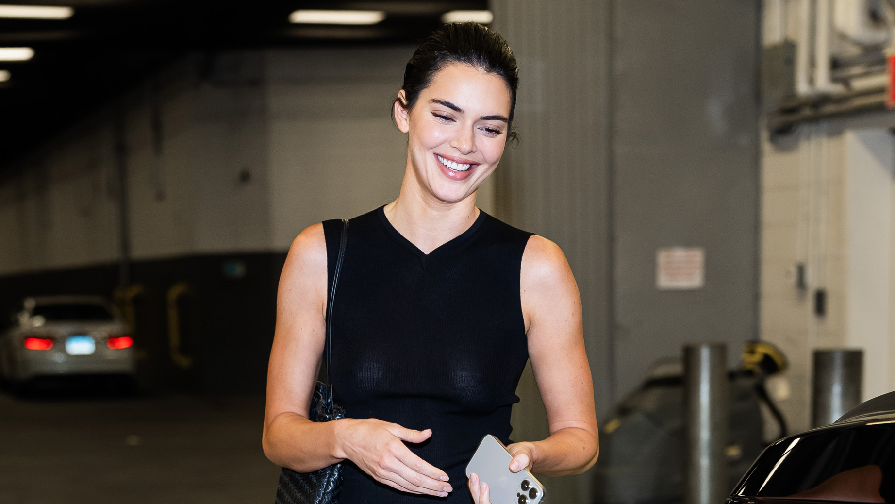 Kendall Jenner wearing a black top and white skirt.